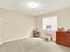 Bedroom with light-colored walls and carpet, containing dresser and play grocery store at 11556 W Cooper Pl, Littleton, CO 80127