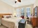 Comfortable bedroom with neutral colors, ceiling fan, and multiple windows at 11556 W Cooper Pl, Littleton, CO 80127