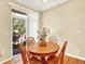 Cozy breakfast nook features a round table with sliding glass door to the yard at 11556 W Cooper Pl, Littleton, CO 80127