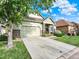 Well-maintained home exterior, features a driveway, a partial lawn, and nice stone details at 11556 W Cooper Pl, Littleton, CO 80127