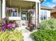 Inviting front porch with stone columns, decorative plants, and seating area at 11556 W Cooper Pl, Littleton, CO 80127