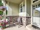 Charming front porch detail featuring stone accents and cozy seating at 11556 W Cooper Pl, Littleton, CO 80127