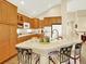 Bright kitchen boasts a large island with seating and wood cabinets at 11556 W Cooper Pl, Littleton, CO 80127