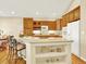 Bright kitchen features light wood cabinetry, a center island, and dining area at 11556 W Cooper Pl, Littleton, CO 80127