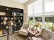 Inviting living room filled with light from a large window and views of the landscaped yard at 11556 W Cooper Pl, Littleton, CO 80127