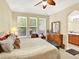 Spacious primary bedroom with three windows, sitting bench and view into ensuite at 11556 W Cooper Pl, Littleton, CO 80127
