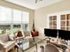 Bright home office with large windows providing lots of natural light and a glass desk at 11556 W Cooper Pl, Littleton, CO 80127