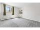 Empty bedroom with large window, carpet and accent wall at 7740 W 35Th Ave # 210, Wheat Ridge, CO 80033