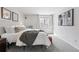 Bright bedroom with a cozy bed, decorative wall art, and a view of the greenery at 7740 W 35Th Ave # 210, Wheat Ridge, CO 80033