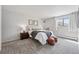 Cozy bedroom with a comfortable bed, soft carpet, and natural light from the window at 7740 W 35Th Ave # 210, Wheat Ridge, CO 80033