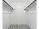 Empty walk-in closet with carpet and clothing rods at 7740 W 35Th Ave # 210, Wheat Ridge, CO 80033