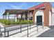 Charming brick commercial property with outdoor patio and awning featuring accessible entrance and lush landscaping at 7740 W 35Th Ave # 210, Wheat Ridge, CO 80033