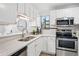 Clean kitchen featuring white cabinets, quartz countertops, and stainless steel appliances at 7740 W 35Th Ave # 210, Wheat Ridge, CO 80033
