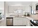 Clean kitchen featuring white cabinets, quartz countertops, and stainless steel appliances at 7740 W 35Th Ave # 210, Wheat Ridge, CO 80033