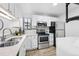 Well-equipped kitchen with white cabinets, quartz countertops, and stainless steel appliances at 7740 W 35Th Ave # 210, Wheat Ridge, CO 80033