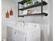 Functional laundry area with modern washer and dryer, complemented by convenient shelving at 7740 W 35Th Ave # 210, Wheat Ridge, CO 80033