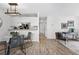 Stylishly designed living space flows into kitchen with wood floors and modern light fixture at 7740 W 35Th Ave # 210, Wheat Ridge, CO 80033