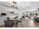 Open-concept living space with modern lighting, dining area, and view into the comfortable living room at 7740 W 35Th Ave # 210, Wheat Ridge, CO 80033