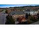 Aerial view of home exterior with a deck and a patio in a neighborhood with mountain views at 8312 Hackamore Rd, Littleton, CO 80125