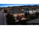 Aerial view of a beautiful home exterior with mountains in the background at twilight at 8312 Hackamore Rd, Littleton, CO 80125