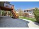 The backyard patio features a well-maintained lawn, a stone patio, and a staircase to upper deck at 8312 Hackamore Rd, Littleton, CO 80125