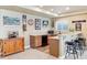 Basement bar area featuring granite countertops, stylish stools, and baseball themed decor at 8312 Hackamore Rd, Littleton, CO 80125