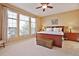 Serene main bedroom with large windows, neutral tones, and wood furniture creating a relaxing retreat at 8312 Hackamore Rd, Littleton, CO 80125