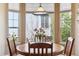 Bright breakfast nook featuring a wooden table set near large windows providing natural light and outdoor views at 8312 Hackamore Rd, Littleton, CO 80125