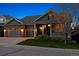 Beautiful home featuring a three-car garage and inviting front porch at 8312 Hackamore Rd, Littleton, CO 80125