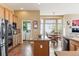 Bright kitchen boasts stainless steel appliances, island and dining nook, and a connected laundry room at 8312 Hackamore Rd, Littleton, CO 80125