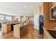 Spacious kitchen features tile flooring, central island and granite countertops, and modern appliances at 8312 Hackamore Rd, Littleton, CO 80125