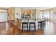 Open concept kitchen and dining area with breakfast bar, stainless steel appliances, and tile floor at 8312 Hackamore Rd, Littleton, CO 80125