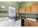 Bright laundry room featuring modern washer and dryer, ample storage space and a window for natural light at 8312 Hackamore Rd, Littleton, CO 80125