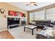 Comfortable living room features a sectional sofa, built-in shelving and fireplace, complemented by natural light from windows at 8312 Hackamore Rd, Littleton, CO 80125