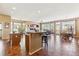Open-concept living space featuring tile flooring, island kitchen, and plenty of natural light at 8312 Hackamore Rd, Littleton, CO 80125