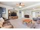 Spacious living room with a ceiling fan and a wooden entertainment center is perfect for entertaining or relaxing at 8312 Hackamore Rd, Littleton, CO 80125