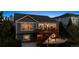 Stunning exterior view showcasing the deck and patio of this elegant home at 8312 Hackamore Rd, Littleton, CO 80125