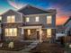 Charming two-story home featuring stone accents, gray siding, and a welcoming front porch at 779 N Tempe St, Aurora, CO 80018