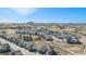 Aerial view of a neighborhood with modern homes, community parks, and distant mountains at 328 Simmental Loop, Castle Rock, CO 80104