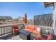 Relaxing back deck featuring outdoor seating, a fire pit table, and scenic views of the community at 328 Simmental Loop, Castle Rock, CO 80104