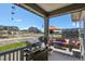 Relax on this back porch with a grill, orange umbrella, and views of the playground and neighborhood at 328 Simmental Loop, Castle Rock, CO 80104