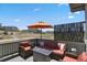Comfortable porch with outdoor seating, an umbrella for shade, and views of the playground and neighborhood at 328 Simmental Loop, Castle Rock, CO 80104