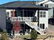 Backyard view showcasing a spacious deck, a covered area, and a well-maintained landscape at 328 Simmental Loop, Castle Rock, CO 80104