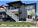 Relaxing backyard featuring a two-story deck, outdoor seating, and well-maintained landscaping at 328 Simmental Loop, Castle Rock, CO 80104