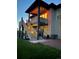 Two-story home at dusk featuring a backyard with a deck, stairs, and lawn at 328 Simmental Loop, Castle Rock, CO 80104
