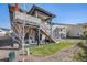 Landscaped backyard features a multi-level deck with outdoor seating and hot tub below at 328 Simmental Loop, Castle Rock, CO 80104
