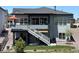 Two-story home showcasing backyard with a deck, stairs, lawn, and rock landscaping at 328 Simmental Loop, Castle Rock, CO 80104
