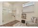 Modern bathroom featuring a glass-enclosed shower, stylish tiles, and a comfortable seating area, creating a spa-like experience at 328 Simmental Loop, Castle Rock, CO 80104