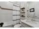 Well-lit bathroom with a tub/shower combo, decorative mirror, and modern fixtures at 328 Simmental Loop, Castle Rock, CO 80104