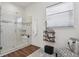 Bright bathroom with glass shower, decorative shelving, and a comfortable chair at 328 Simmental Loop, Castle Rock, CO 80104